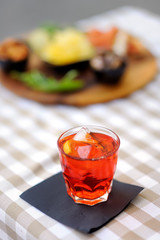 Italian aperitives/aperitif: glass of cocktail (sparkling wine with Aperol) and appetizer platter...