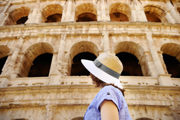 Young female traveler looking on famous the Colosseum in Rome.