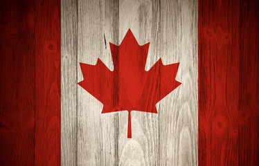 Canadian flag with wood grain textured background. National flag of Canada with maple leaf.