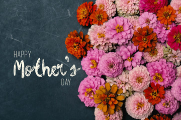 Zinnia flowers in group with Mother's Day text on chalkboard background for holiday graphic.