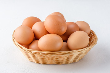 Red chicken eggs in a basket.
