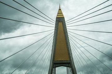 Beautiful suspension bridge poles are fastened by steel wire ropes in Bangkok province of Thailand