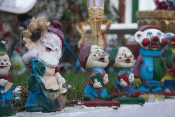 Colorful dwarf figures decorating house garden. Little funny statues on front yard