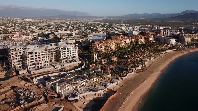 Aerial view of Medano Beach in Cabo San Lucas with the majestic sea at front. Hotels and the city behind. Shot at first hours in the morning. Baja California Sur, Mexico.
