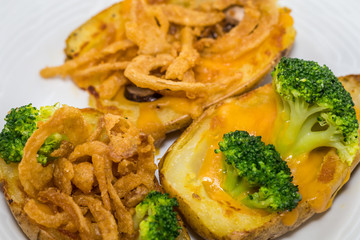 Potato Skins appetizer with broccoli, cheddar cheese and fried onions