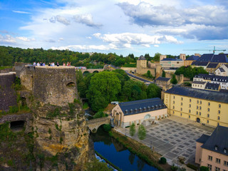 Fototapeta na wymiar View of the Alzette river in the old town of Luxembourg City, Luxembourg, with St. John Church (church of St. John or St. Jean du Grund) in one side and the wall in other side