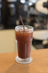 Iced Americano coffee.Background with coffee machine and barista.