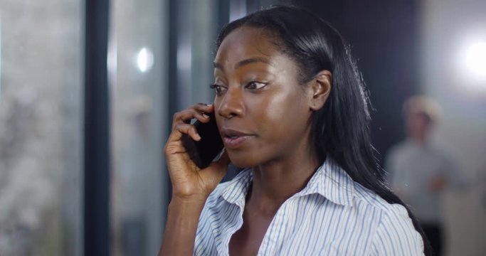 4k, Businesswoman annoyed & upset by phone call, shaking her head in disbelief. Slow motion.