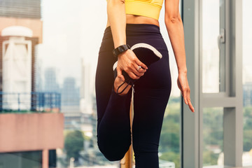 Beautiful Asian woman doing stretching exercise. Female fitness model at gym with copy space