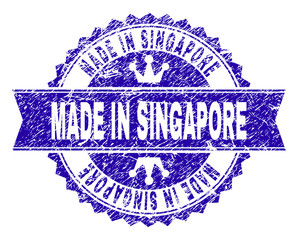 MADE IN SINGAPORE rosette seal watermark with distress texture. Designed with round rosette, ribbon and small crowns. Blue vector rubber watermark of MADE IN SINGAPORE label with retro texture.