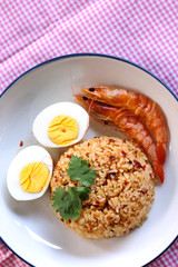 Thai chili paste fried rice, boiled egg and sweet shrimp on white plate and space for write wording, easy cook meal for home making or served in restaurant, popular for foreigner or tourist