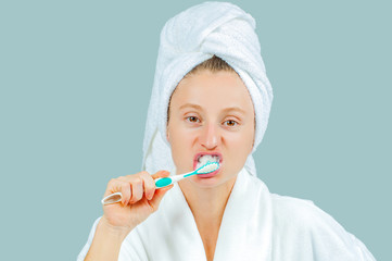 Spa and beauty concept. Beautiful woman brushing teeth.