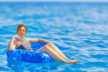 Woman relax on inflatable ring in sea water