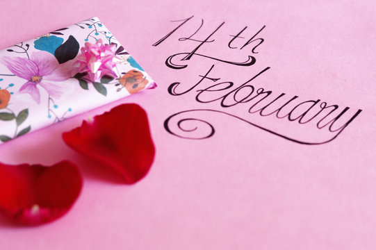 14th february lettering with gift and petals