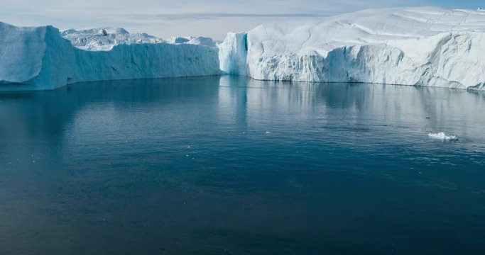 Global Warming and Climate Change - Giant Iceberg from melting glacier in Ilulissat, Greenland. Aerial drone of arctic nature landscape famous for being heavily affected by global warming.