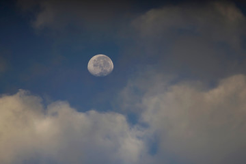 Moon with deep blue sky and cloud