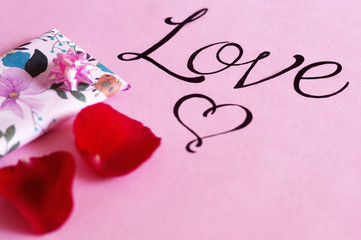 love lettering with gift and petals