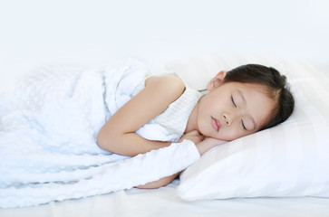 Sleeping beautiful Asian child girl lying on bed.