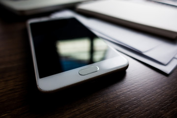 Close up office desk table with laptop, note book, mobile coffee and pen. Selective focus. Business concept. Copy space.