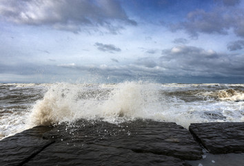 Stormy sea, the waves break on the rocks