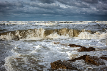 Stormy sea, the waves break on the rocks
