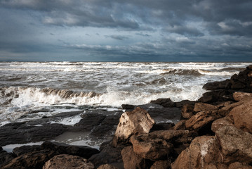 Stormy sea, the waves break on the rocks
