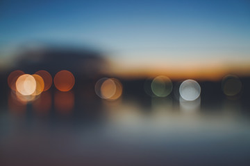 Sunset twilight round shape blurred bokeh reflection river front, abstract background