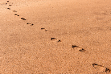 Human footprints on the yellow loose sand