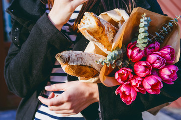 Frenchwoman with baguettes on the street in beret