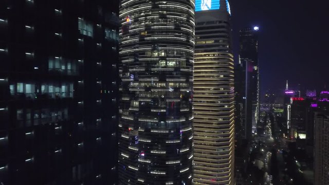 Asia, China. Guangzhou city center at night with illuminated office buildings and Canton tower in the background