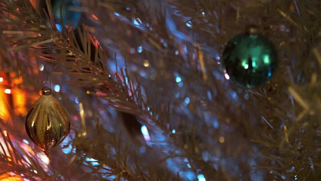 Aluminum Christmas Tree Branch Detail. Color Wheel casting colors onto branches & ornaments.