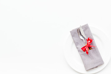 Romantic dinner on Valentine's day concept. Decorated dishes, tableware on white background top view copy space