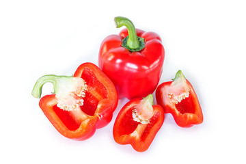 red bell pepper cut into pieces on white background, top view.