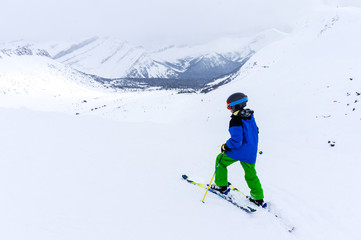 Fototapeta na wymiar Young Skier on top of Mountain at Lake Louise in the Canadian Rockies