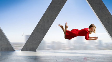 Woman fly in air and use mobile. Mixed media