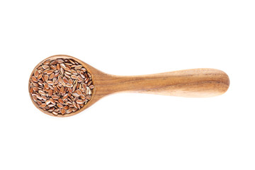 Brown flax seed in spoon on white background.