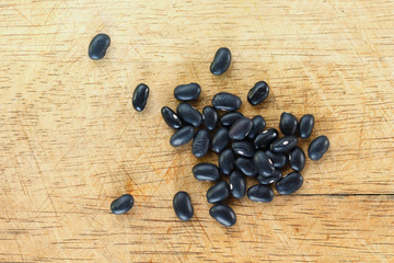 Heap Black bean on wooden background.