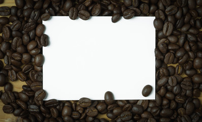White paper note and coffee bean,soft focus.