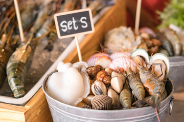 Nicely placed shrimp, mussels, seafood on ice in a bucket. Dining.