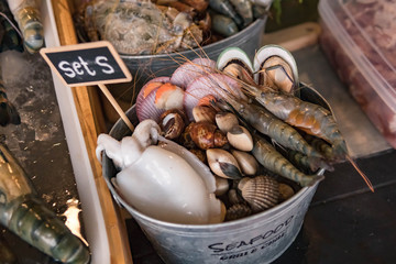 Nicely placed shrimp, mussels, seafood on ice in a bucket. Dining.