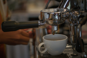 coffee pouring in a cup from the machine