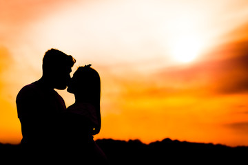 Fototapeta premium couple kissing at sunset