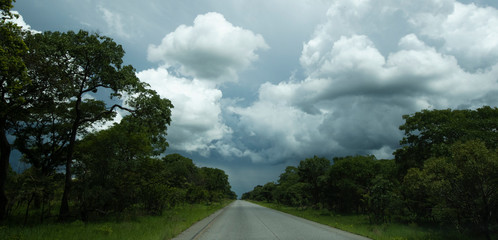 Clouds over paved road zambia