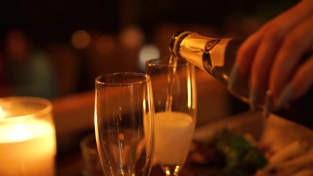 Close Up - New Year's Eve - Pouring a glass of champagne at a luxury restaurant