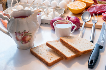 Preparing Bread with tea cup and kitchenware, egetable and meat on table
