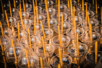 Unlighted candles with handle for buddhist ceremony.