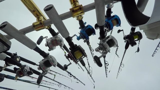 Fishing rods shot from the ground up on a moving boat.