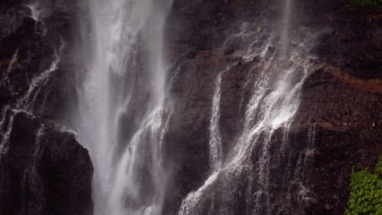 Fototapeta na wymiar waterfall in green rainforest. tropical waterfall in mountain jungle. Bali,Indonesia. Travel concept.