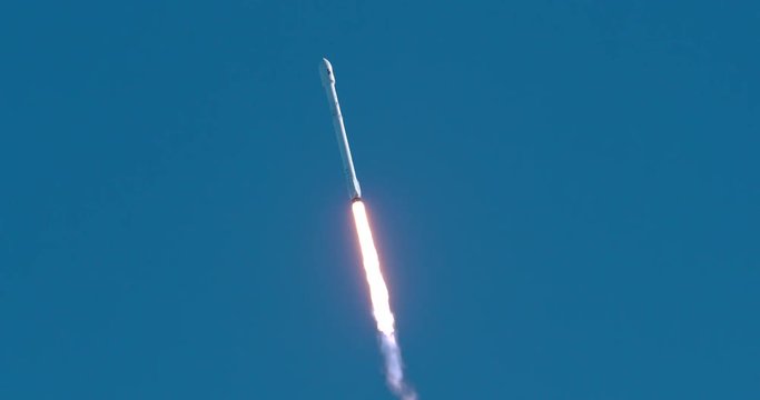 A rocket blasts off and launches a communications satellite into space.  4K at 120 fps slow motion.