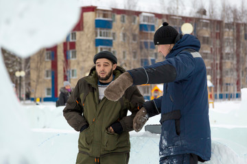 Two workers at the site of the ice camp